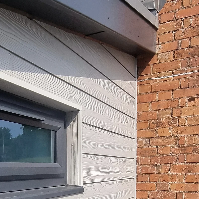 Weatherboard cladding sealed where it meets brickwork
